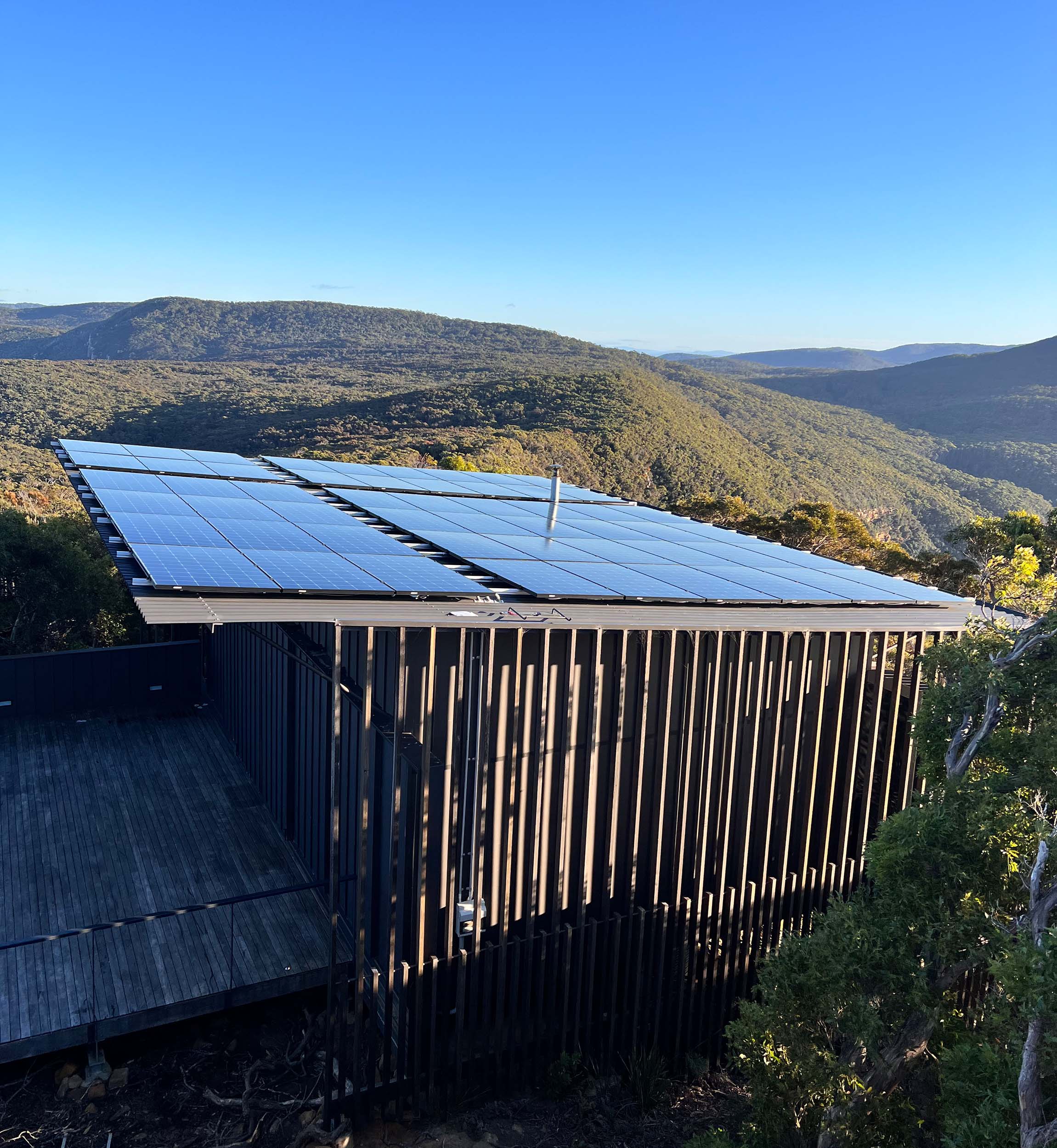 An image of a house sitting in the mountains.